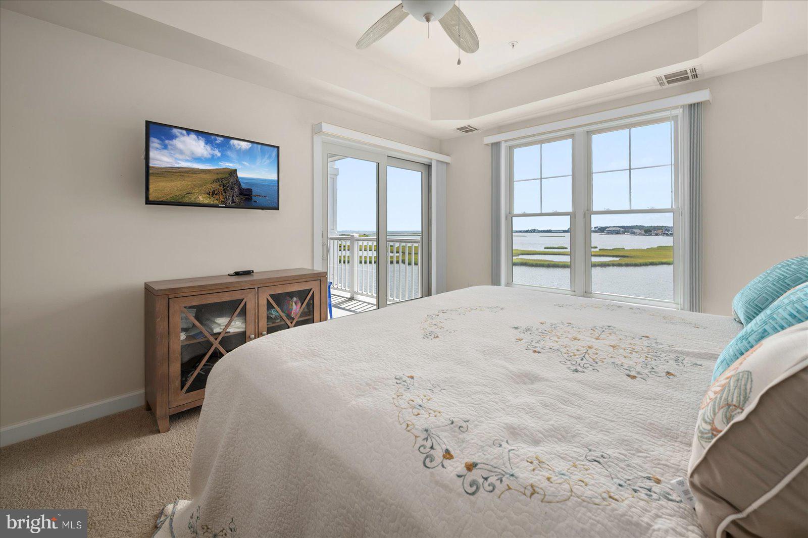 37292 Lighthouse Road, Unit 202 Selbyville, DE 19975 - Photo 27 of 78 a bedroom with a bed and a flat screen tv