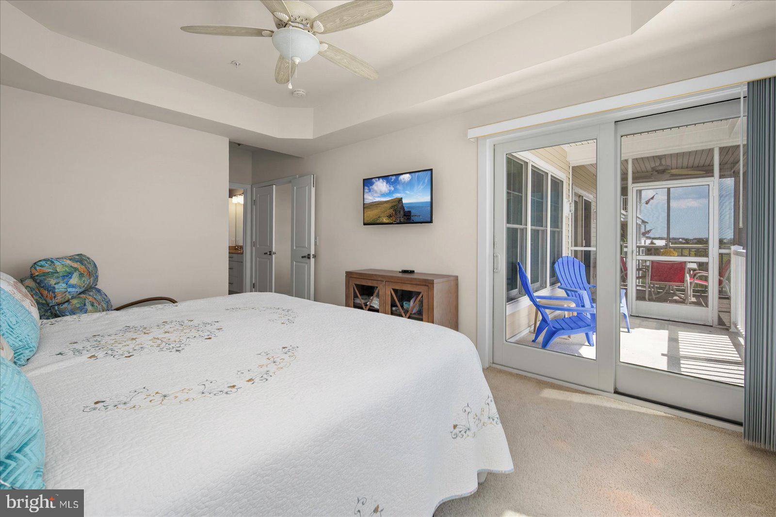 37292 Lighthouse Road, Unit 202 Selbyville, DE 19975 - Photo 30 of 78 a bedroom with a bed and a large mirror