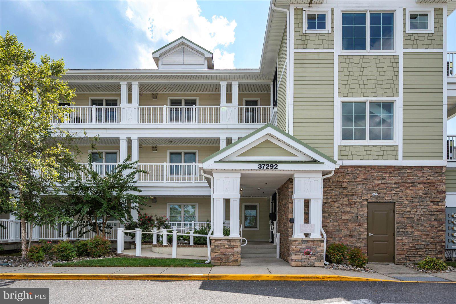 37292 Lighthouse Road, Unit 202 Selbyville, DE 19975 - Photo 3 of 78 a front view of a house with a swimming pool