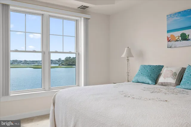 a living room with furniture a flat screen tv and a window