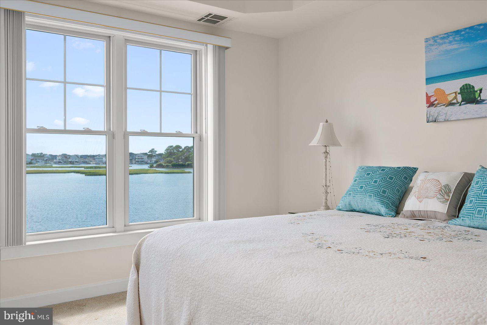 37292 Lighthouse Road, Unit 202 Selbyville, DE 19975 - Photo 32 of 78 a bedroom with a large bed and a window