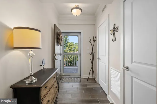 a living room with furniture kitchen view and a chandelier