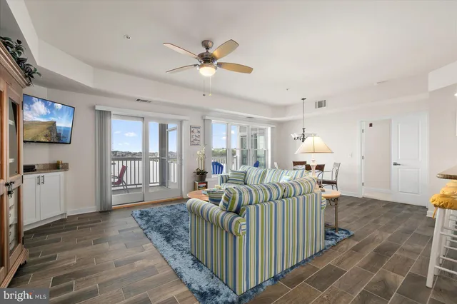 a living room with furniture a rug and a chandelier
