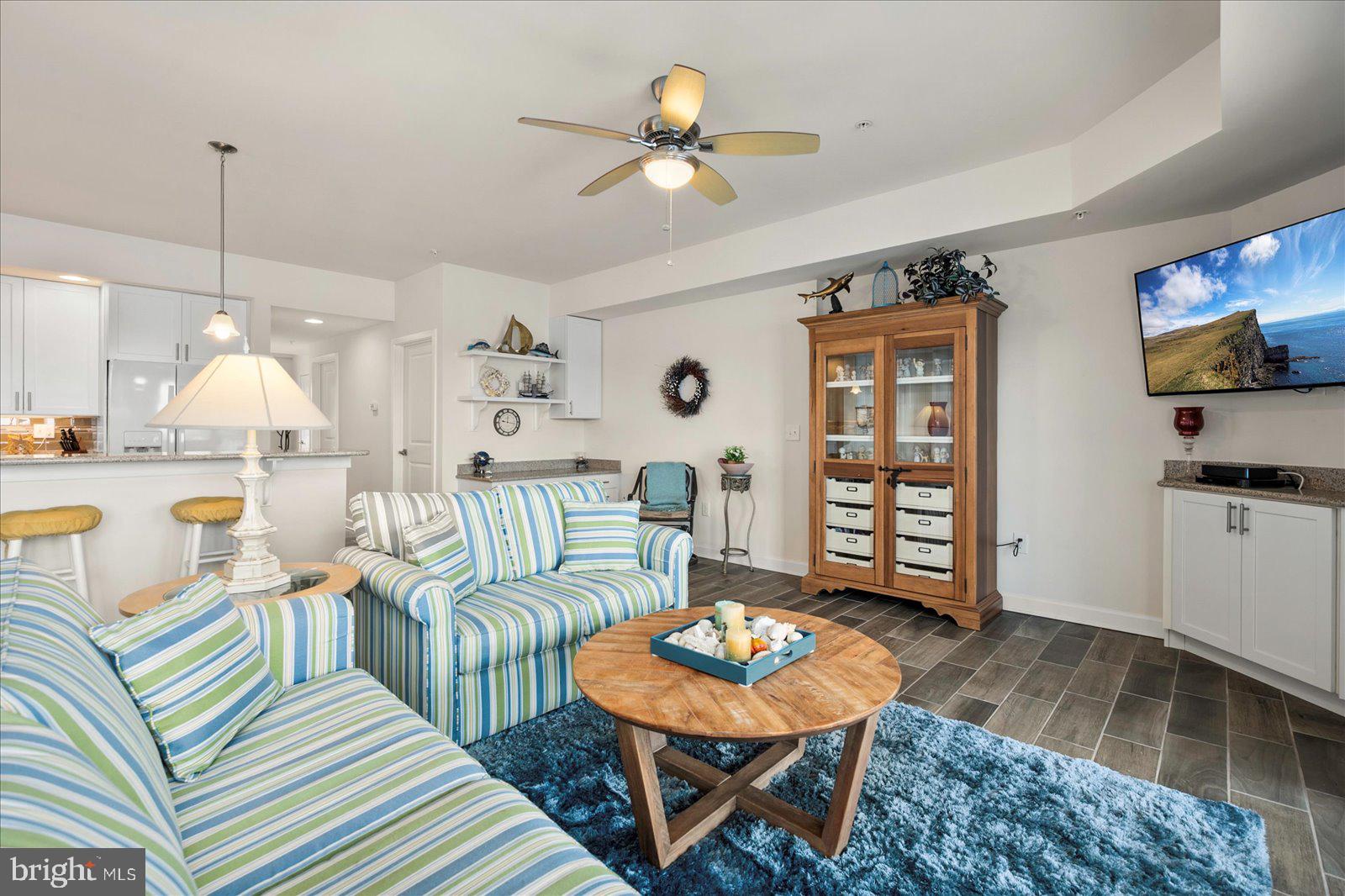 37292 Lighthouse Road, Unit 202 Selbyville, DE 19975 - Photo 9 of 78 a living room with furniture a rug and a chandelier