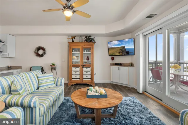 a view of a bedroom with furniture and balcony