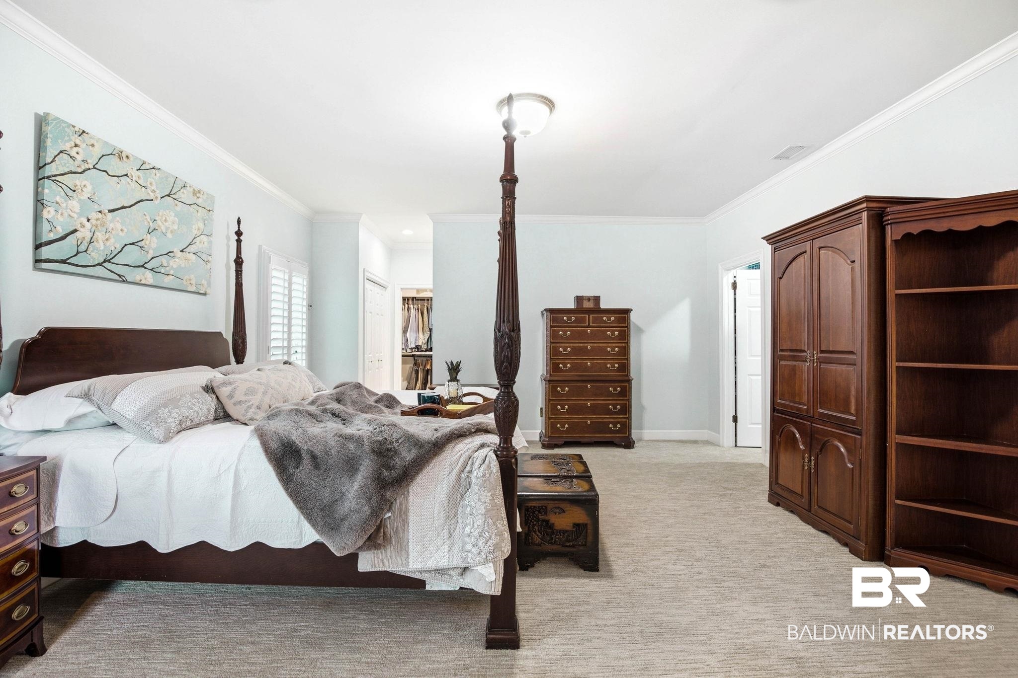 31515 Rhett Drive Spanish Fort, AL 36527 - Photo 30 of 100 The oversize primary suite has TWO walk in closets, a coat closet, a sitting area with an electric fireplace, crown molding, a large linen closet, and plantation shutters. The primary suite measures 16' 2" x 34' 6"