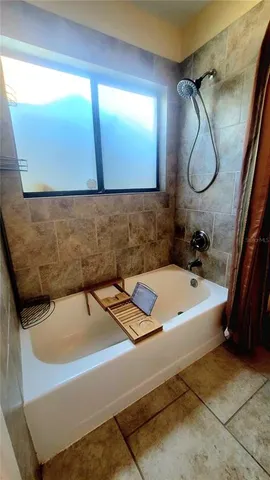 a bathroom with a tub and a mirror