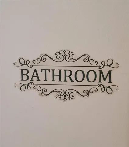 a spacious bathroom with a granite countertop sink a mirror and a bathtub