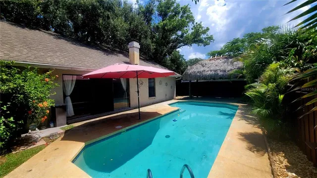 a view of a backyard with a patio and fire pit