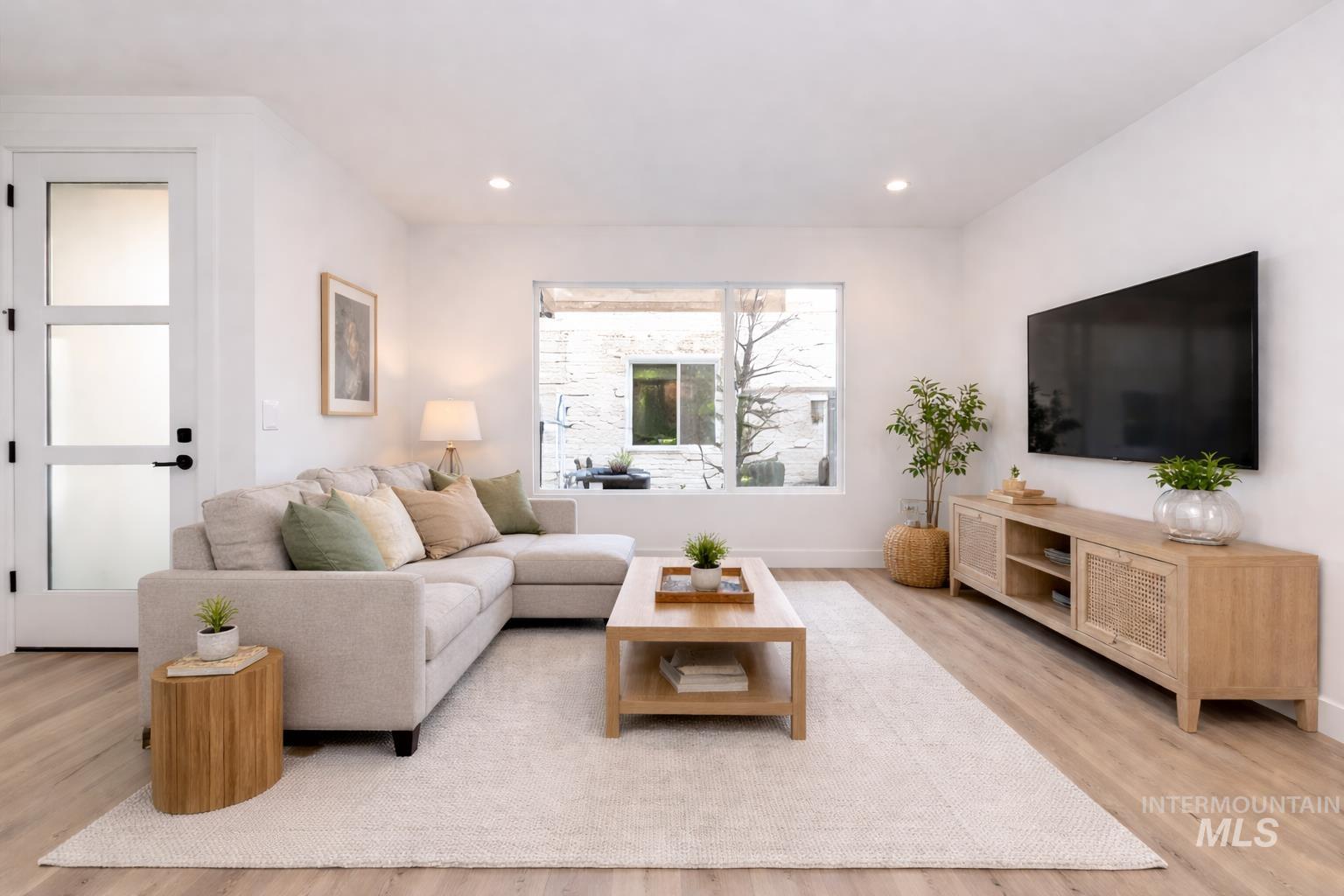 Living area featuring light wood-type flooring and recessed lighting