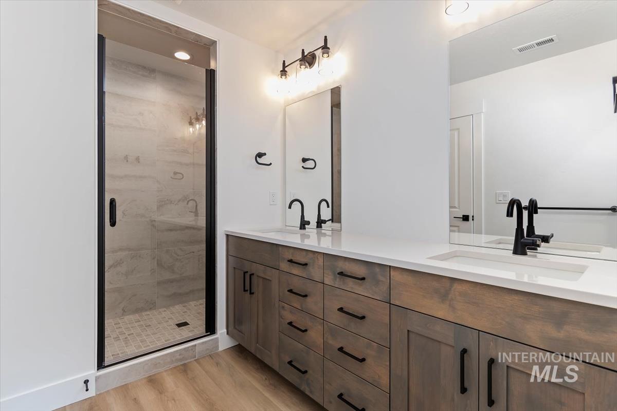 752 South Calhoun Place Star, ID 83669 - Photo 19 of 40 Full bathroom with double vanity, a stall shower, light wood-style flooring, and recessed lighting