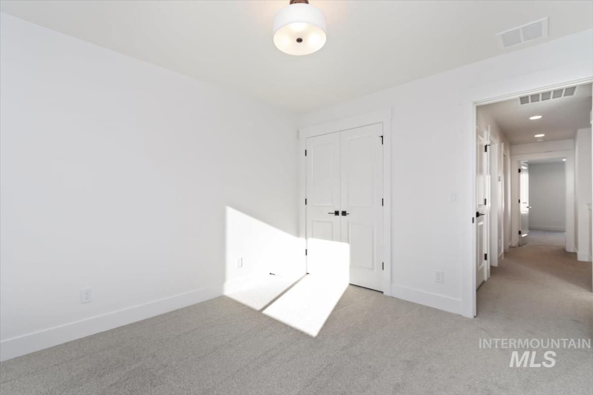 752 South Calhoun Place Star, ID 83669 - Photo 22 of 40 Unfurnished bedroom with light carpet and a closet
