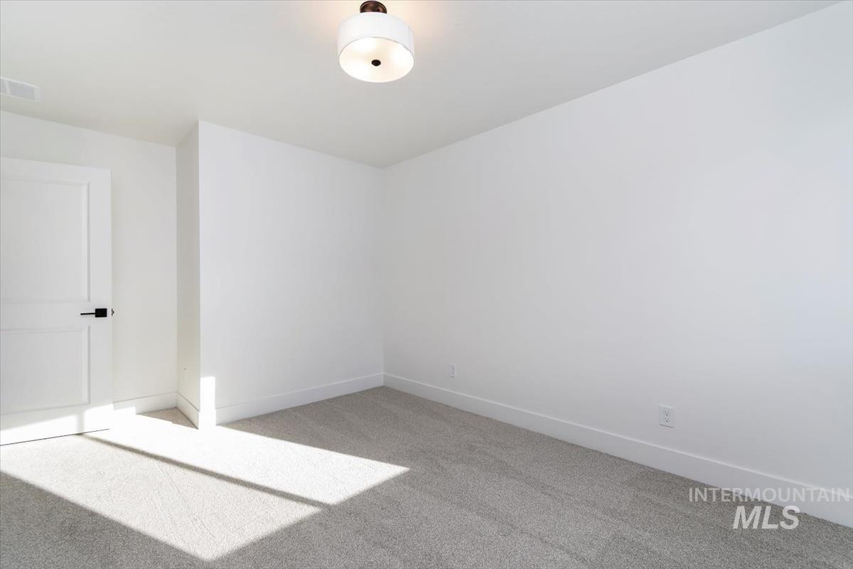 752 South Calhoun Place Star, ID 83669 - Photo 26 of 40 Spare room featuring light colored carpet and baseboards