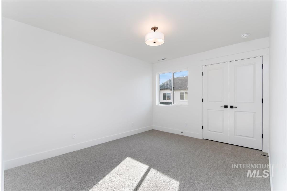 752 South Calhoun Place Star, ID 83669 - Photo 27 of 40 Unfurnished bedroom featuring carpet and baseboards