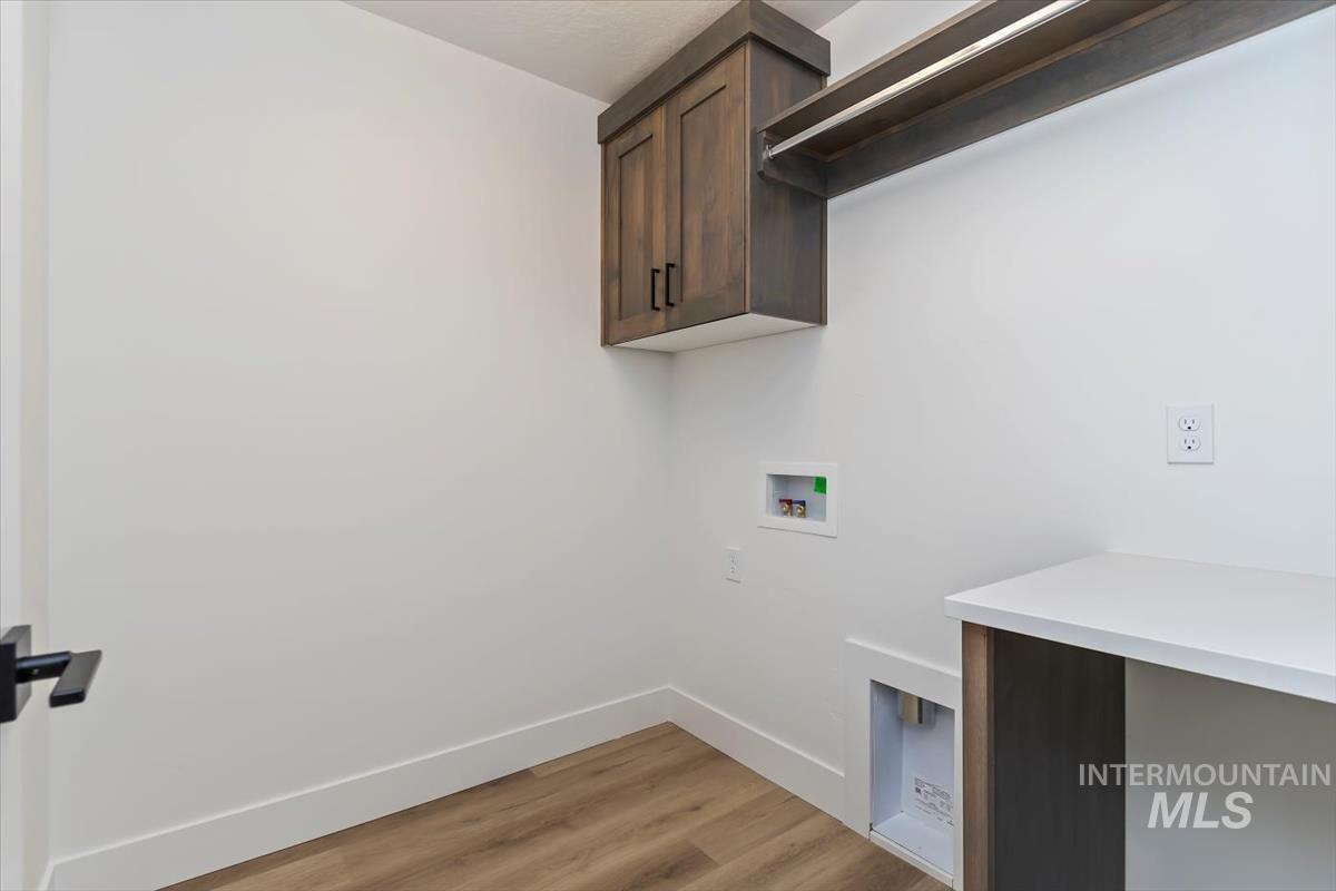 752 South Calhoun Place Star, ID 83669 - Photo 28 of 40 Laundry room with light wood-style floors, washer hookup, and cabinet space