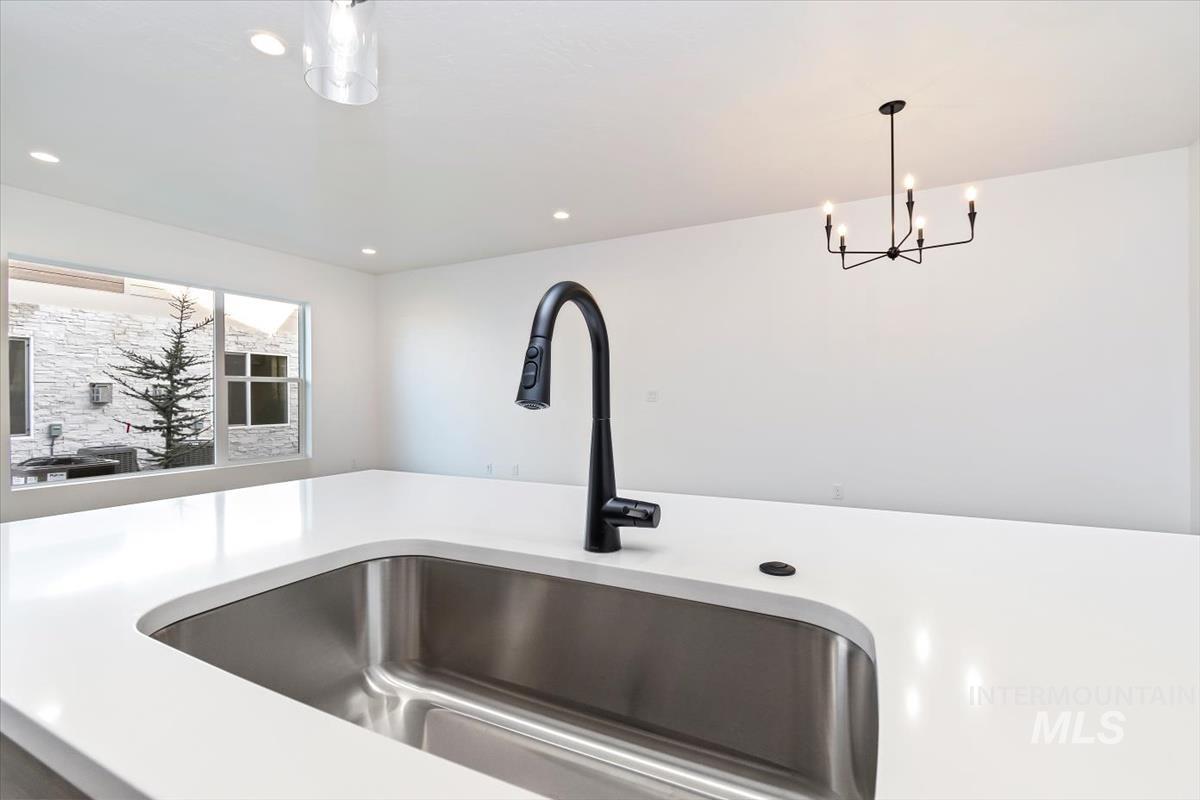 752 South Calhoun Place Star, ID 83669 - Photo 6 of 40 Kitchen view of suspended lighting and light stone counters