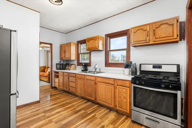 a kitchen with stainless steel appliances granite countertop a stove and a refrigerator