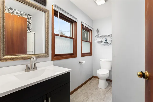 a bathroom with a sink toilet a mirror and shower