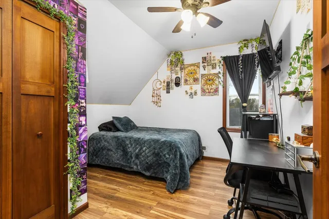 a bedroom with a bed closet and a window