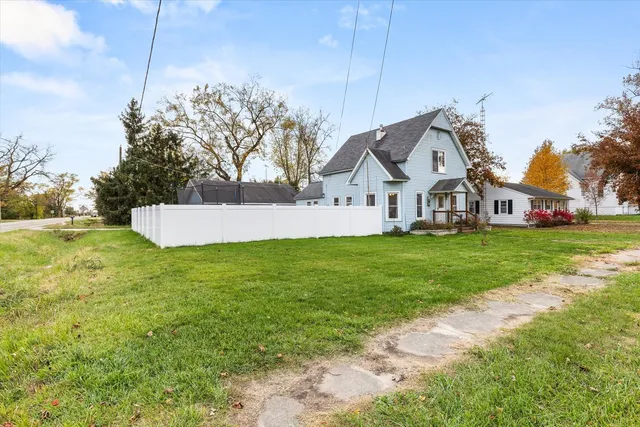 a view of a house with a yard and garage