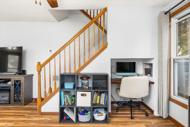 a living room with furniture a flat screen tv and a wall painting