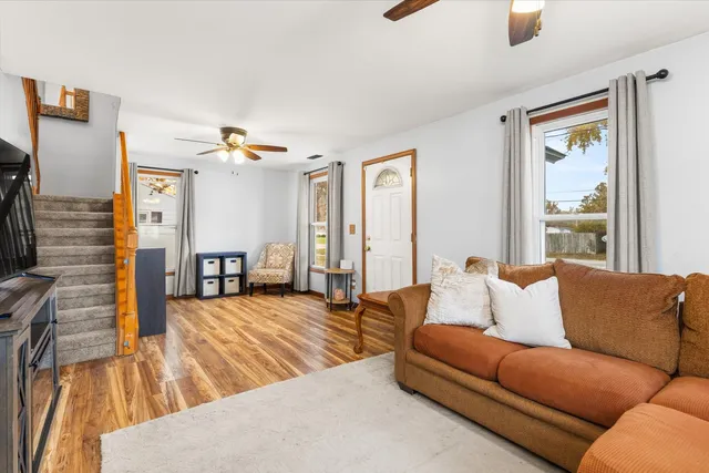 a living room with furniture and a wooden floor