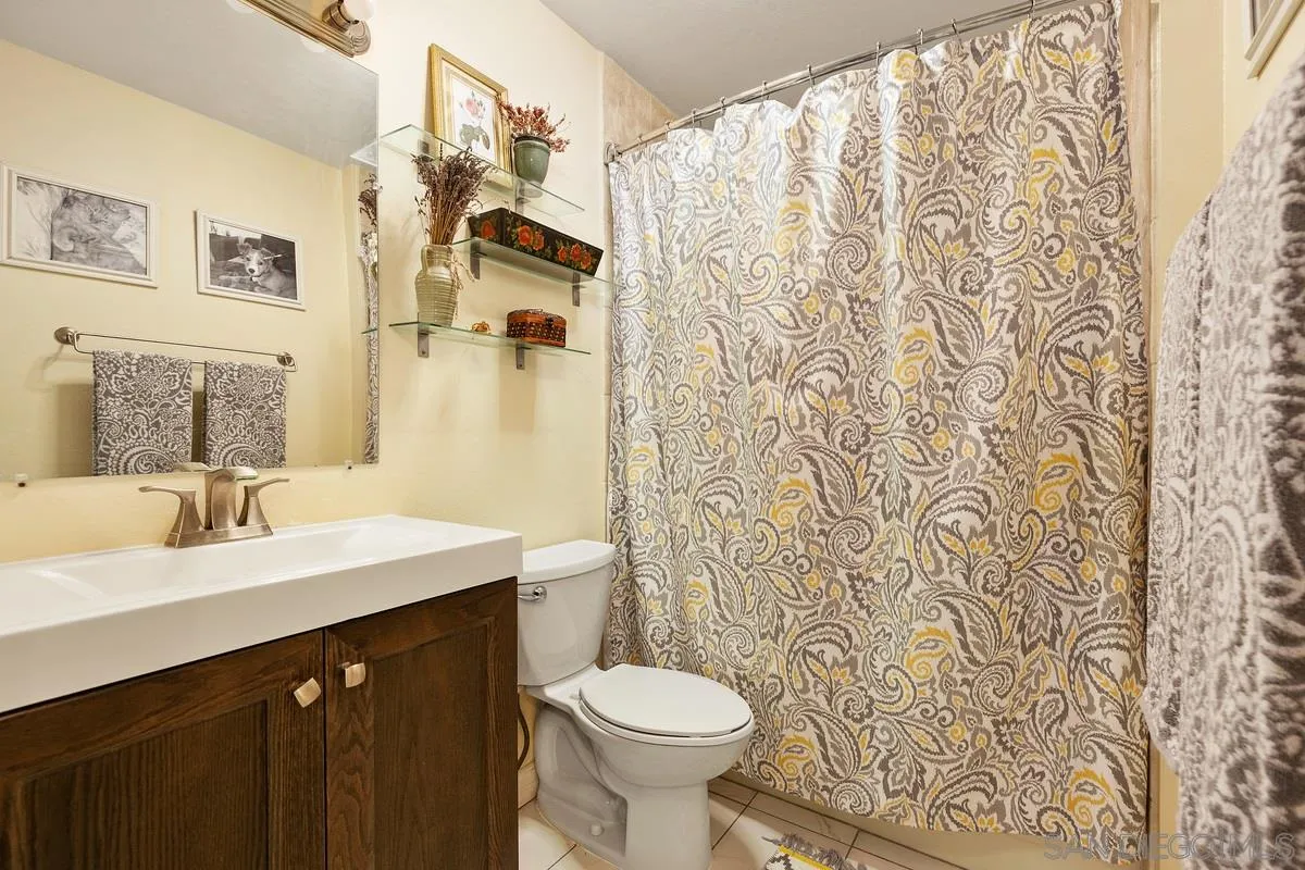 6191 Rancho Mission Road, Unit 304 San Diego, CA 92108 - Photo 23 of 31 a bathroom with a sink and a mirror