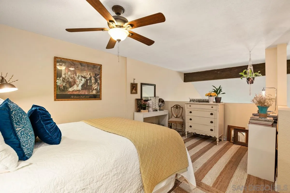 6191 Rancho Mission Road, Unit 304 San Diego, CA 92108 - Photo 6 of 31 a bedroom with furniture and a chandelier