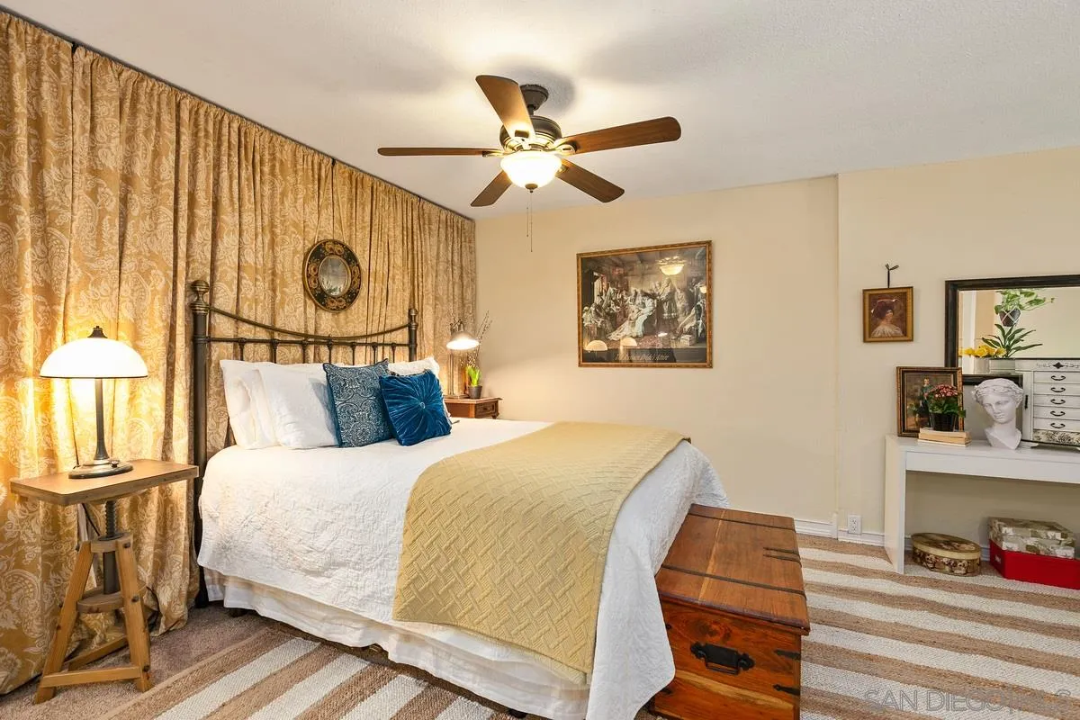 6191 Rancho Mission Road, Unit 304 San Diego, CA 92108 - Photo 7 of 31 a bedroom with a bed and a chandelier