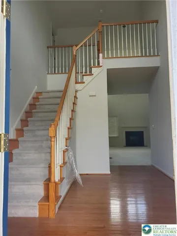 a view of entryway and hall with wooden floor