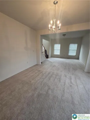 a view of a chandelier and fireplace in a room