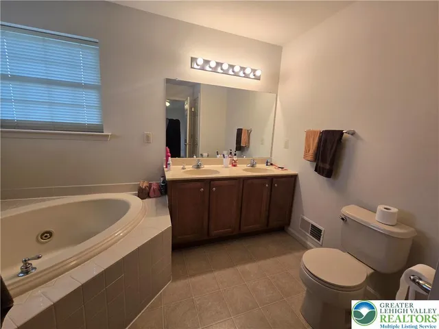 a bathroom with a sink a toilet and bathtub