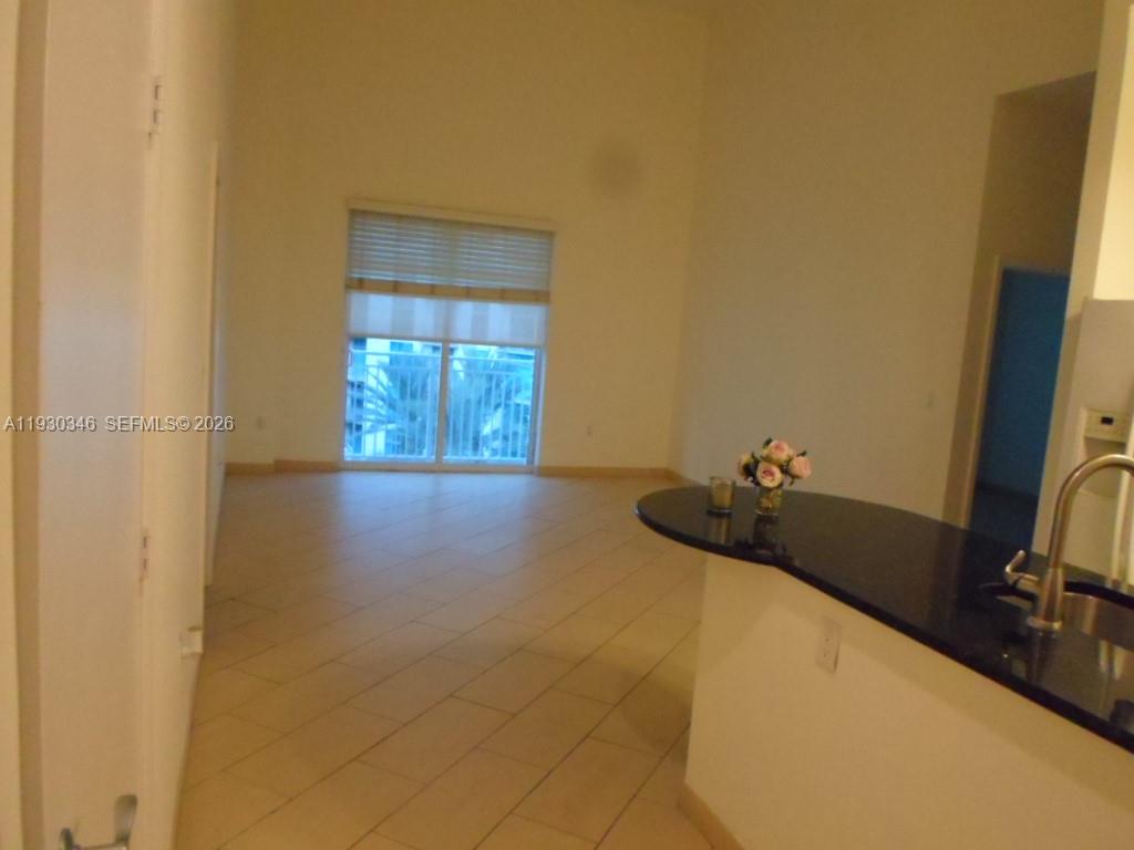 7275 Southwest 90th Way, Unit G 611 Miami, FL 33156 - Photo 43 of 56 a bedroom with a bed and a chandelier