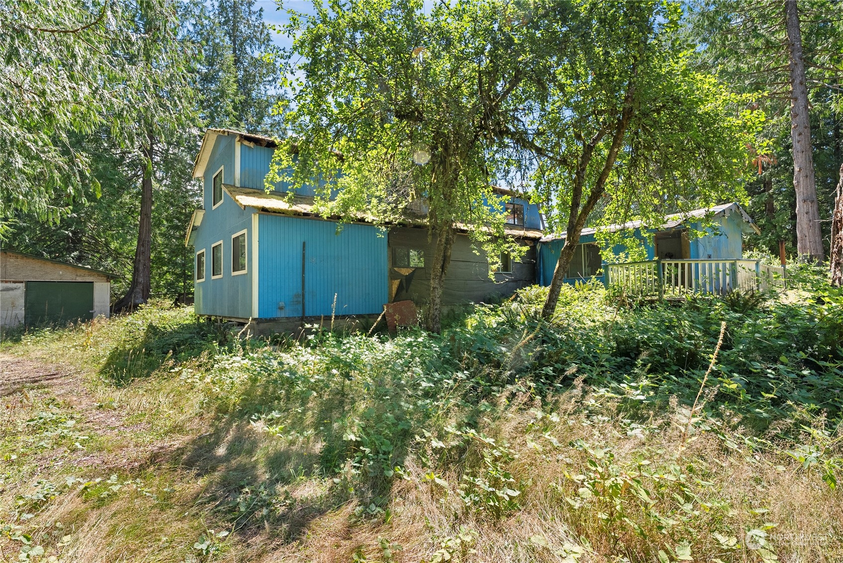66 Peter Hagen Road Northwest Seabeck, WA 98380 - Photo 15 of 26 a view of a house with a yard