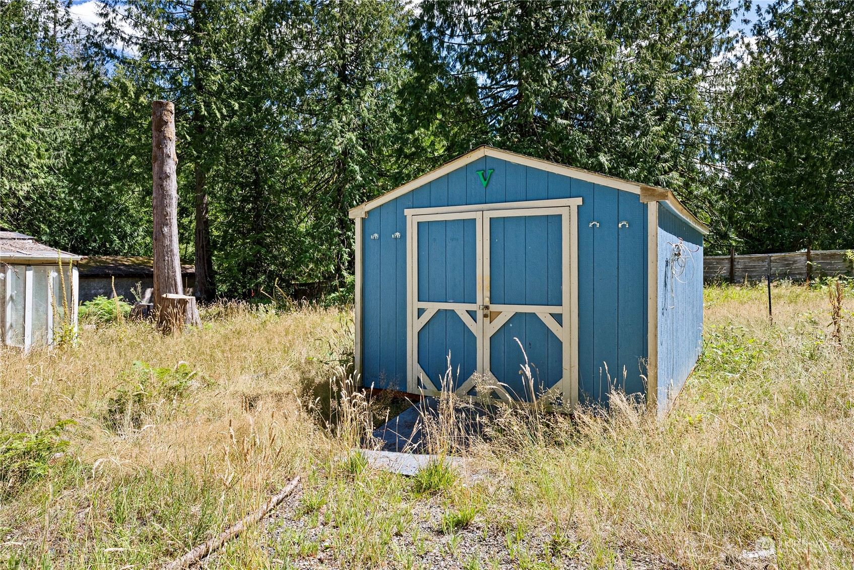 66 Peter Hagen Road Northwest Seabeck, WA 98380 - Photo 16 of 26 a backyard of a house with large trees and plants