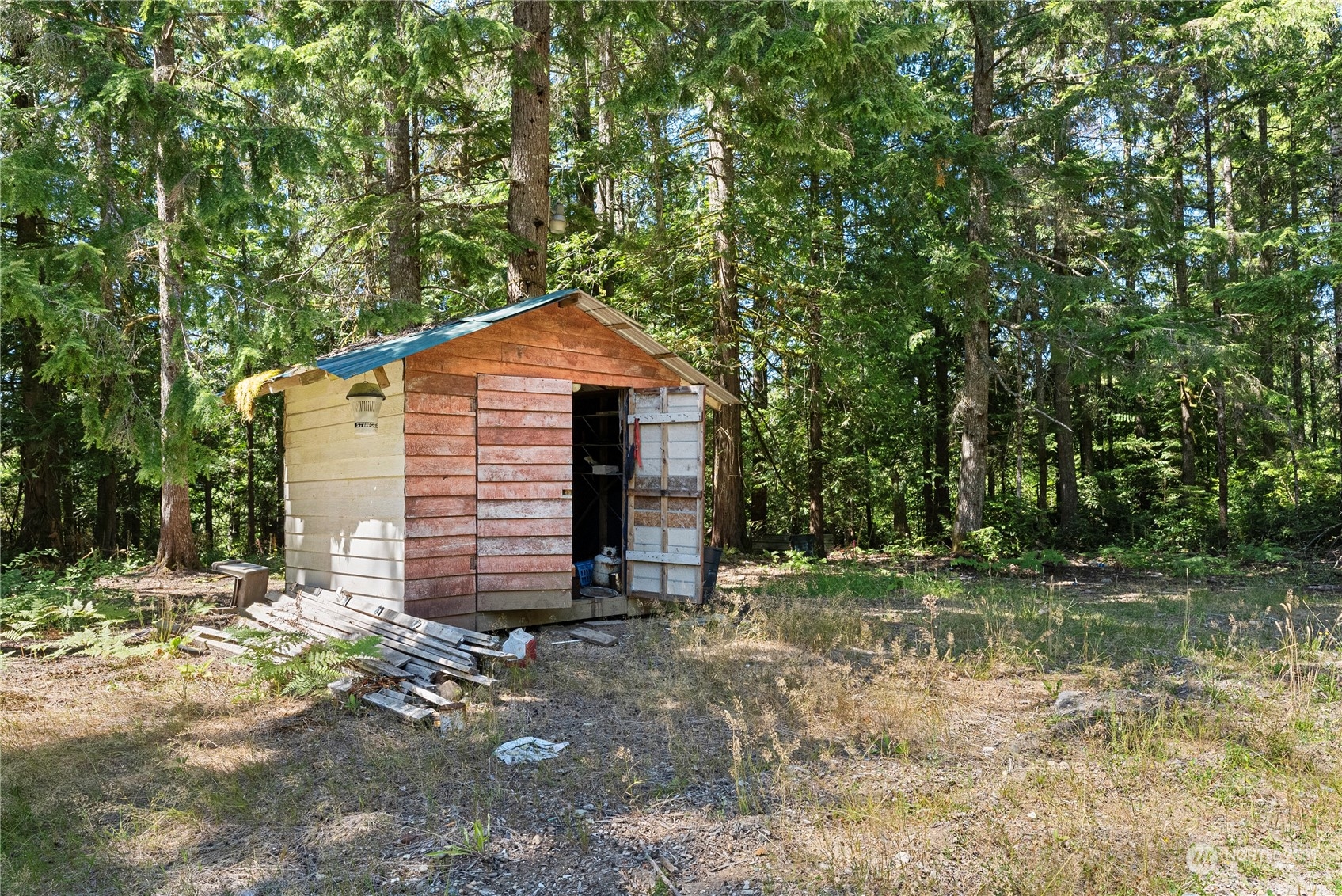 66 Peter Hagen Road Northwest Seabeck, WA 98380 - Photo 17 of 26 a front view of a house with a yard