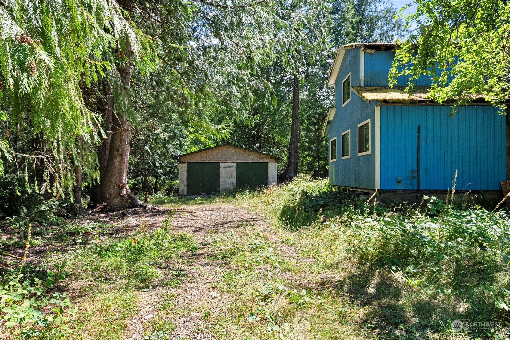 66 Peter Hagen Road Northwest Seabeck, WA 98380 - Photo 2 of 26 a front view of a house with garden