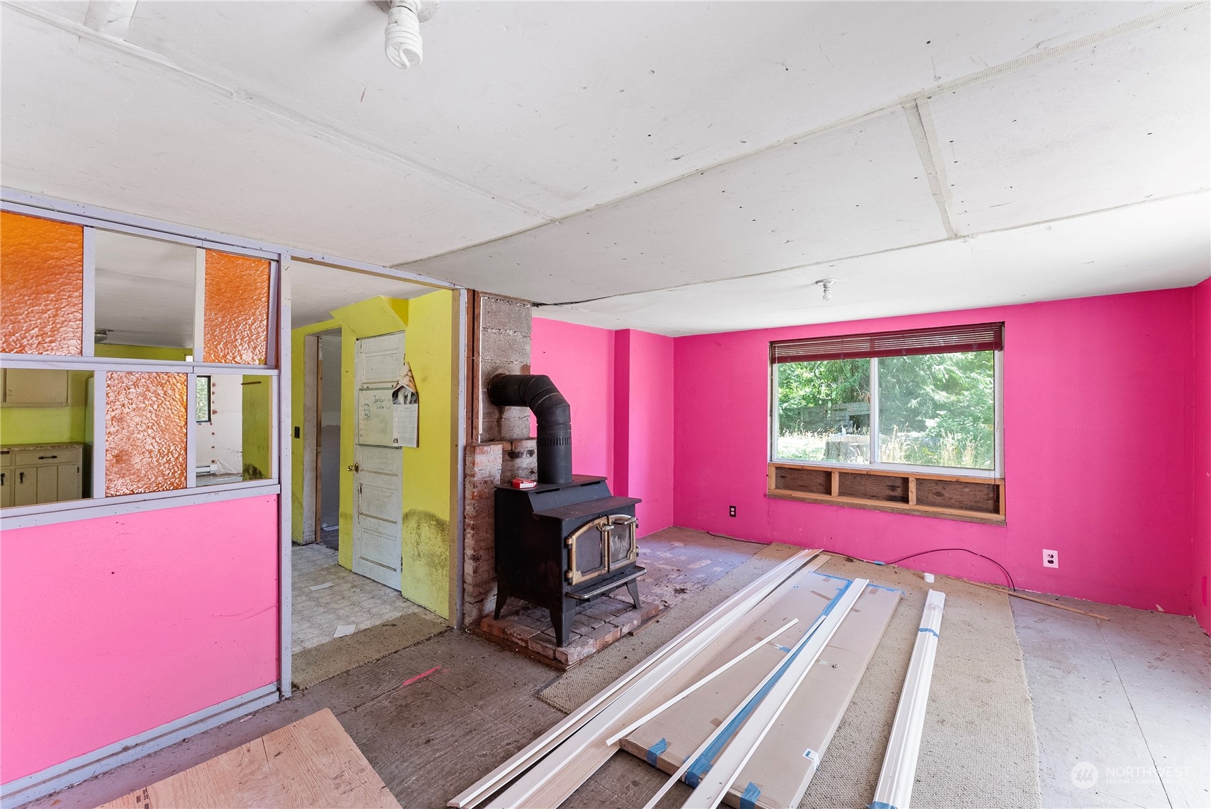 66 Peter Hagen Road Northwest Seabeck, WA 98380 - Photo 7 of 26 a living room with furniture a flat screen tv and a floor to ceiling window