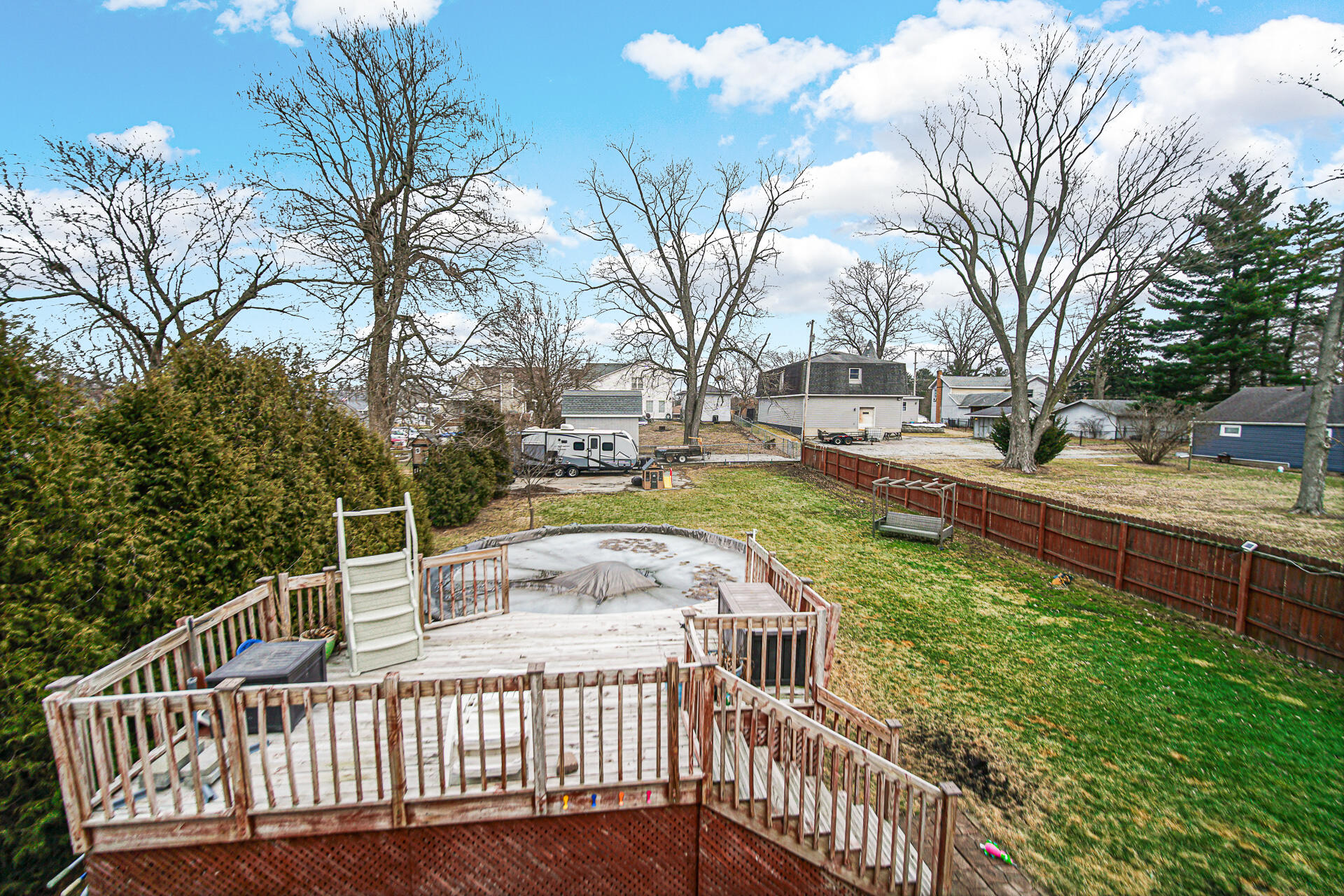 505 North Washington Street Hebron, IN 46341 - Photo 25 of 27 a view of a roof deck with couches and wooden fence