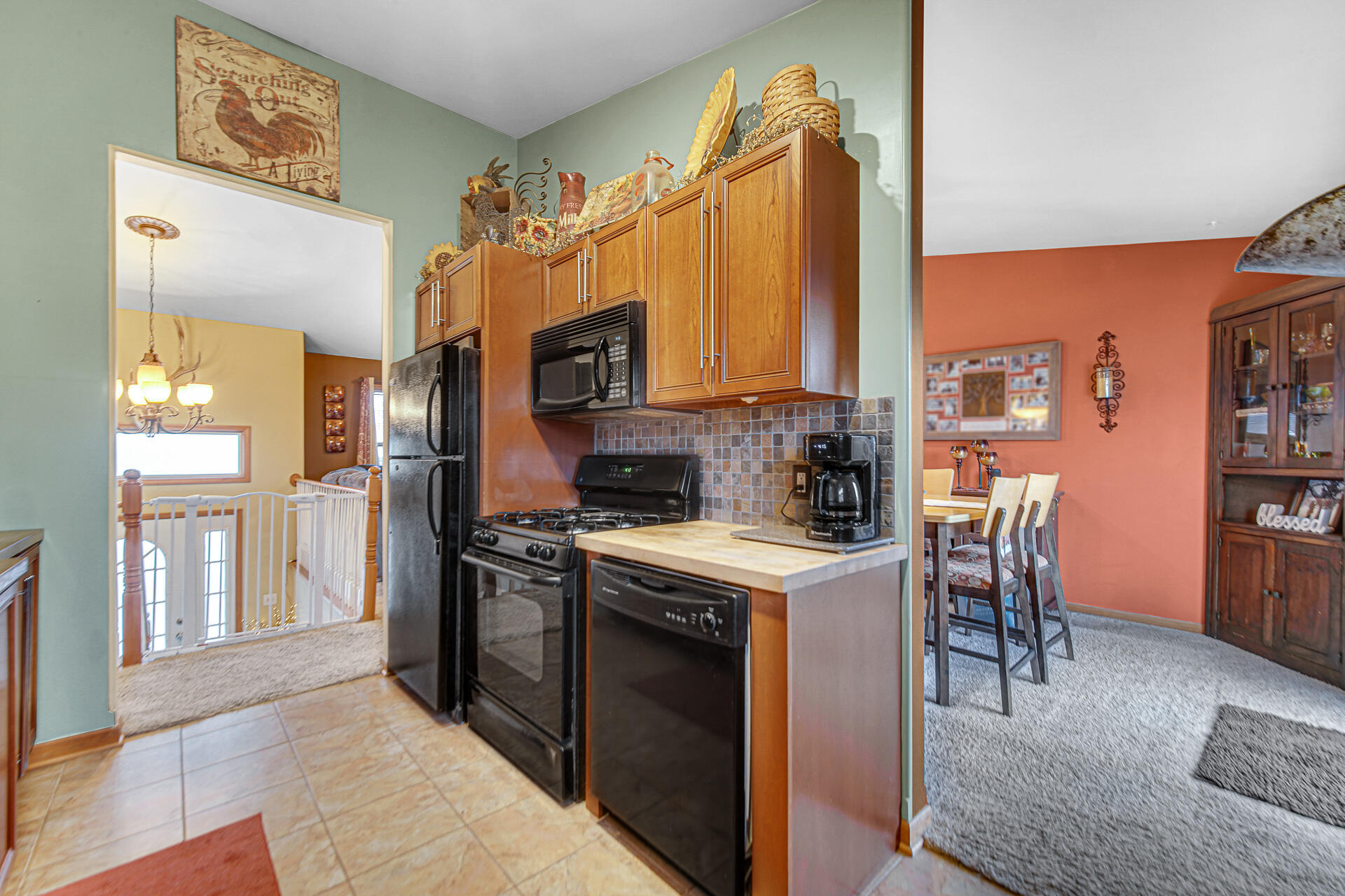 505 North Washington Street Hebron, IN 46341 - Photo 10 of 27 a kitchen with stainless steel appliances granite countertop a stove top oven a sink a dining table and chairs