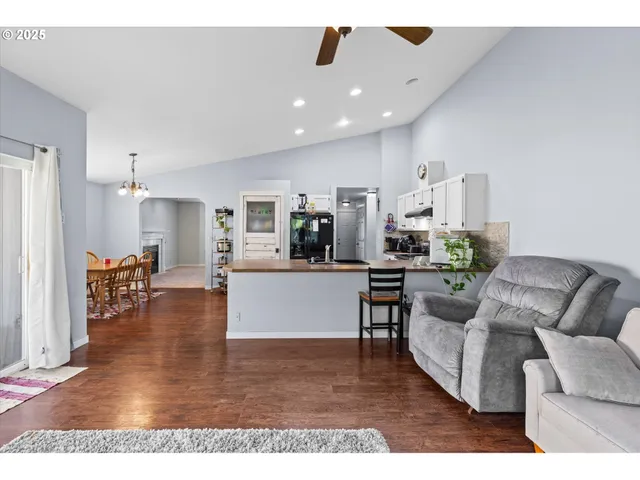 a living room with furniture and kitchen view