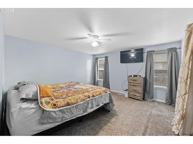 a bedroom with a bed and a television