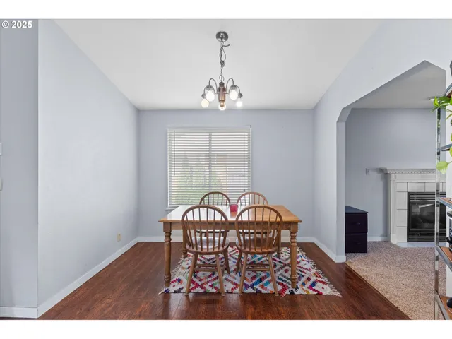 a view of a dining room with furniture and chandelier