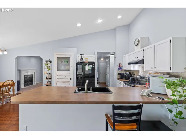 a living room with furniture and potted plants