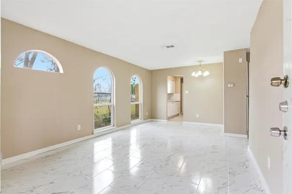 a view of a big room with windows and cabinet