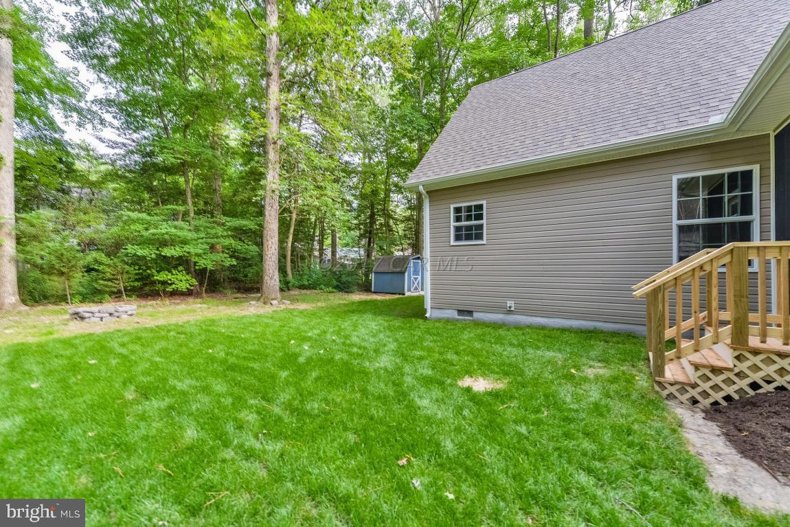173 Sandyhook Road Ocean Pines, MD 21811 - Photo 11 of 40 a view of backyard of house with green space