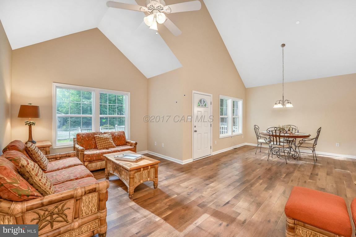 173 Sandyhook Road Ocean Pines, MD 21811 - Photo 23 of 40 a living room with furniture and a floor to ceiling window