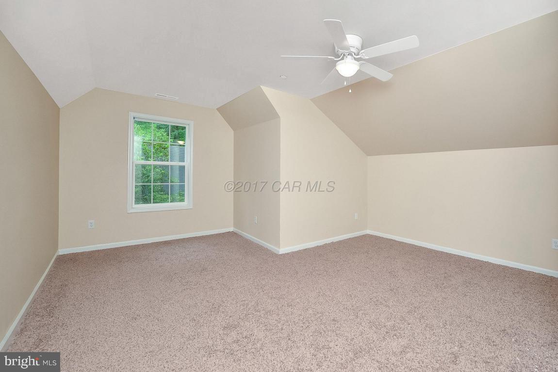 173 Sandyhook Road Ocean Pines, MD 21811 - Photo 34 of 40 an empty room with windows and ceiling fan