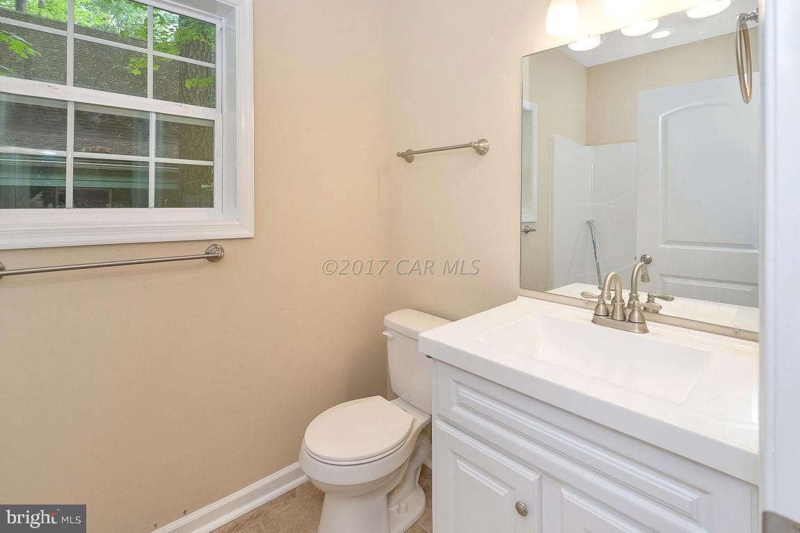 173 Sandyhook Road Ocean Pines, MD 21811 - Photo 38 of 40 a bathroom with a sink a toilet and a mirror