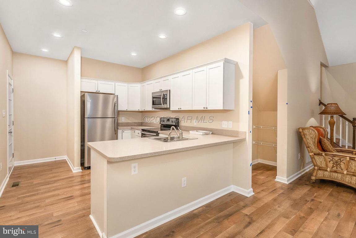 173 Sandyhook Road Ocean Pines, MD 21811 - Photo 5 of 40 a kitchen with stainless steel appliances granite countertop a sink stove and refrigerator